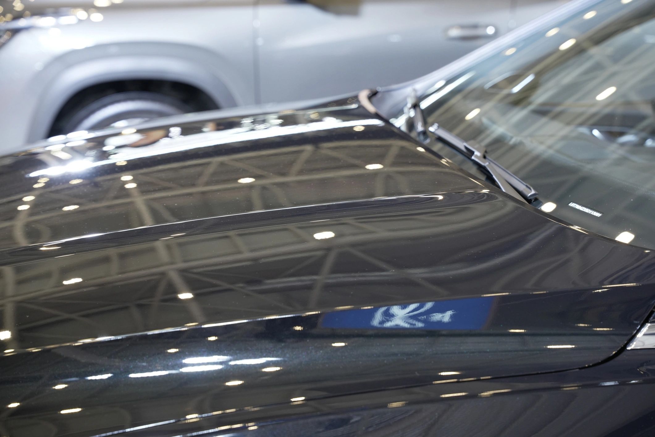 Glossy car hood reflecting light after polishing